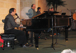 Pianist and other stage performers, with circular light spots (angel orbs) in the photograph