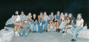 Church group seated together outdoors at night